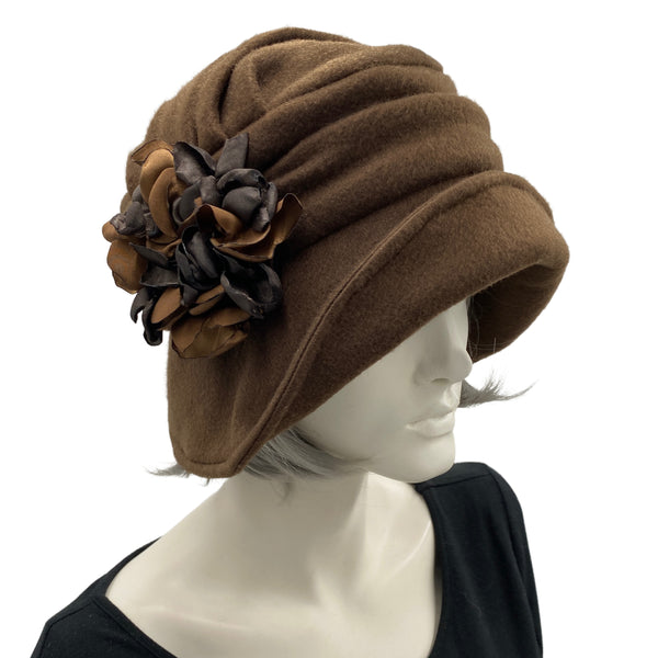 Alice wide from brim cloche hat for women handmade in brown fleece with satin hydrangea brooch in shades of brown Boston Millinery  modeled on a hat mannequin front side view 