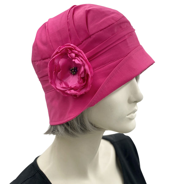 Very lightweight cotton cloche hat in magenta pink with satin flower brooch shown modeled on a hat  mannequin, handmade Boston Millinery, side view 