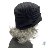 Alice narrow brim in black linen side view showing pleating detail modeled on a mannequin