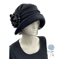 Alice wide front brim cloche hat for women handmade in black fleece with satin hydrangea brooch in shades of brown Boston Millinery modeled on a hat mannequin frontside view