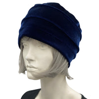 Velvet Cloche Hat and Chemo Headwear in blue with Satin Flower Embellishment modeled on a hat mannequin side view with flower