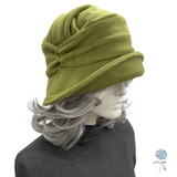 Green fleece hat on a mannequin with gray hair against a white background