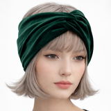 Woman wearing a green headband with a plain background