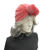 Coral color velvet knot turban shown on mannequin side view