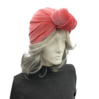 Mannequin head wearing a pink turban on a white background