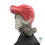 Mannequin head with a pink turban on a white background