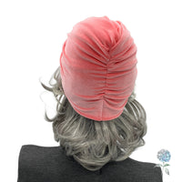 Coral color velvet knot turban shown on mannequin rear view