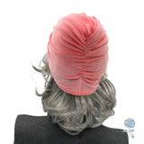 Coral color velvet knot turban shown on mannequin rear view