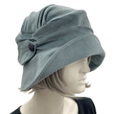 1920s style dusky blue cloche hat for women side view of leaf brooch shown modeled on a mannequin 