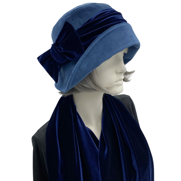 Blue velvet 1920s style cloche hat with velvet bow modeled on a hat mannequin 