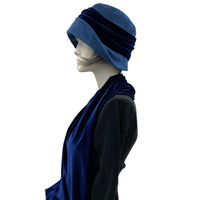 Blue velvet 1920s style cloche hat with velvet bow modeled on a hat mannequin full length showing the matching scarf