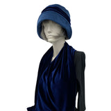 Blue velvet 1920s style cloche hat with velvet bow modeled on a hat mannequin full length side front view 