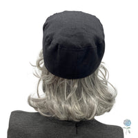 Black linen cadet cap rear view modeled on a mannequin