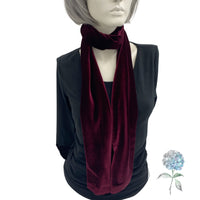 Long velvet scarf in wine/burgundy wrapped around the neck of a mannequin