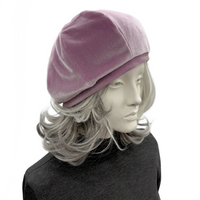 Handmade pale mauve velvet beret in a classic eight-panel design displayed on a mannequin with gray hair, stylish and vintage-inspired.