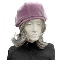 Mannequin head wearing a frosted mauve beret on a white background front view
