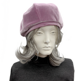 Mannequin head wearing a frosted mauve beret on a white background front view
