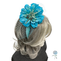 Blue floral hair accessory on a wig with a white background