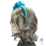 Gray wig with a blue headband featuring a decorative flower on a white background