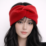 Woman wearing a red headband against a white background