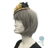 yellow and black flower fascinator shown modeled on a mannequin head Sid eview