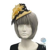 yellow and black flower fascinator shown modeled on a mannequin head side front view