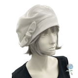 White headscarf with a bow on a mannequin head against a white background