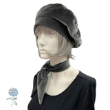 Mannequin wearing a gray beret and matching neckerchief on a white background