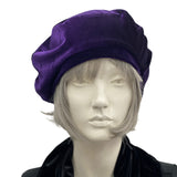 Purple beret handmade in soft velvet. Satin lined hat shown on a mannequin head. Front view. Boston Millinery