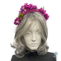 purple pink cherry blossom fascinator headband modeled on a mannequin 