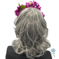purple pink cherry blossom fascinator headband modeled on a mannequin  rear view
