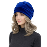 Woman wearing a blue turban on a white background