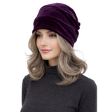 Woman wearing a purple headscarf on a white background
