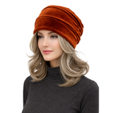 Woman wearing an orange headscarf on a white background