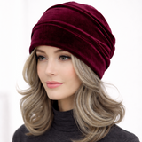 Woman wearing a burgundy headscarf on a white background