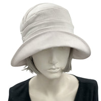 Alice Cloche hat for women handmade in white linen top front view. Modeled on a hat mannequin. Boston Millinery 