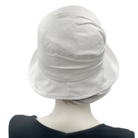 Alice Cloche hat for women handmade in white linen rear view. Modeled on a hat mannequin. Boston Millinery 