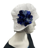 Alice cloche narrow brim hat  hat in antique white linen with blues hydrangea petal brooch side view