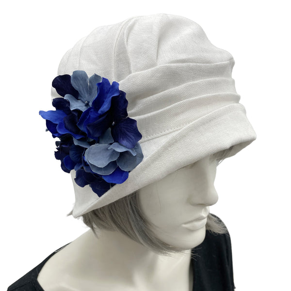 Alice cloche narrow brim hat  hat in antique white linen with blues hydrangea petal brooch Boston Millinery