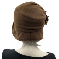 Alice wide from brim cloche hat for women handmade in brown fleece with satin hydrangea brooch in shades of brown Boston Millinery  modeled on a hat mannequin  rear view