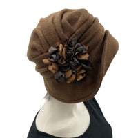 Alice wide from brim cloche hat for women handmade in brown fleece with satin hydrangea brooch in shades of brown Boston Millinery  modeled on a hat mannequin  side flower view