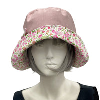 Betty cloche hat in dusky pink linen with pink cotton floral brim and bow  front view