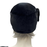 Simple black velvet toque with satin and lace flower brooch rear view