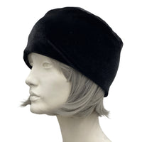 Simple black velvet toque with satin and lace flower brooch side view
