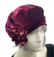 burgundy velvet beret with a pretty hydrangea petal brooch handmade in velvet and satin. modelled on a hat manequin boston millinery 