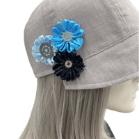 Polly Cloche cap in gray linen with ribbon flowers blue turquoise black 