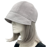 Polly Cloche cap in gray linen with ribbon flowers side view plain