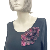 Large Eggplant color hydrangea petal brooch shown modeled on a mannequin 