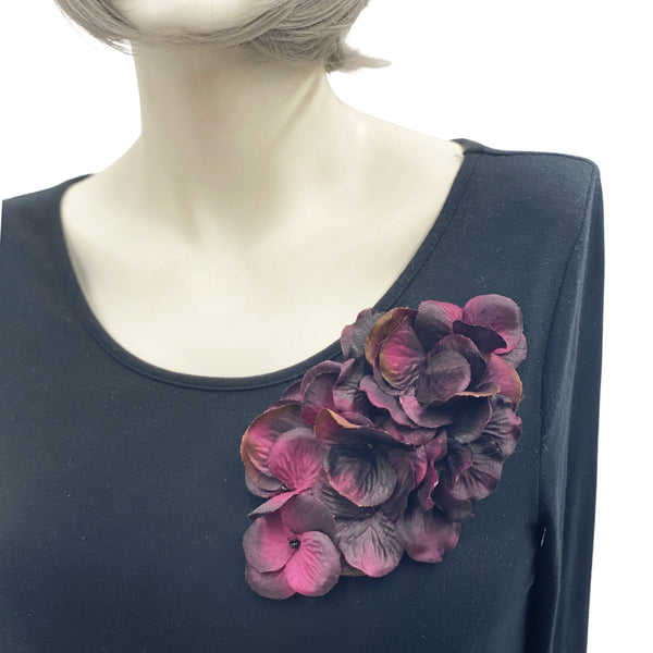 Large Eggplant color hydrangea petal brooch shown modeled on a mannequin 