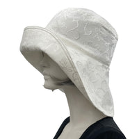Eleanor Derby Brim damask fabric with large white peony brooch cloche hat women plain side view